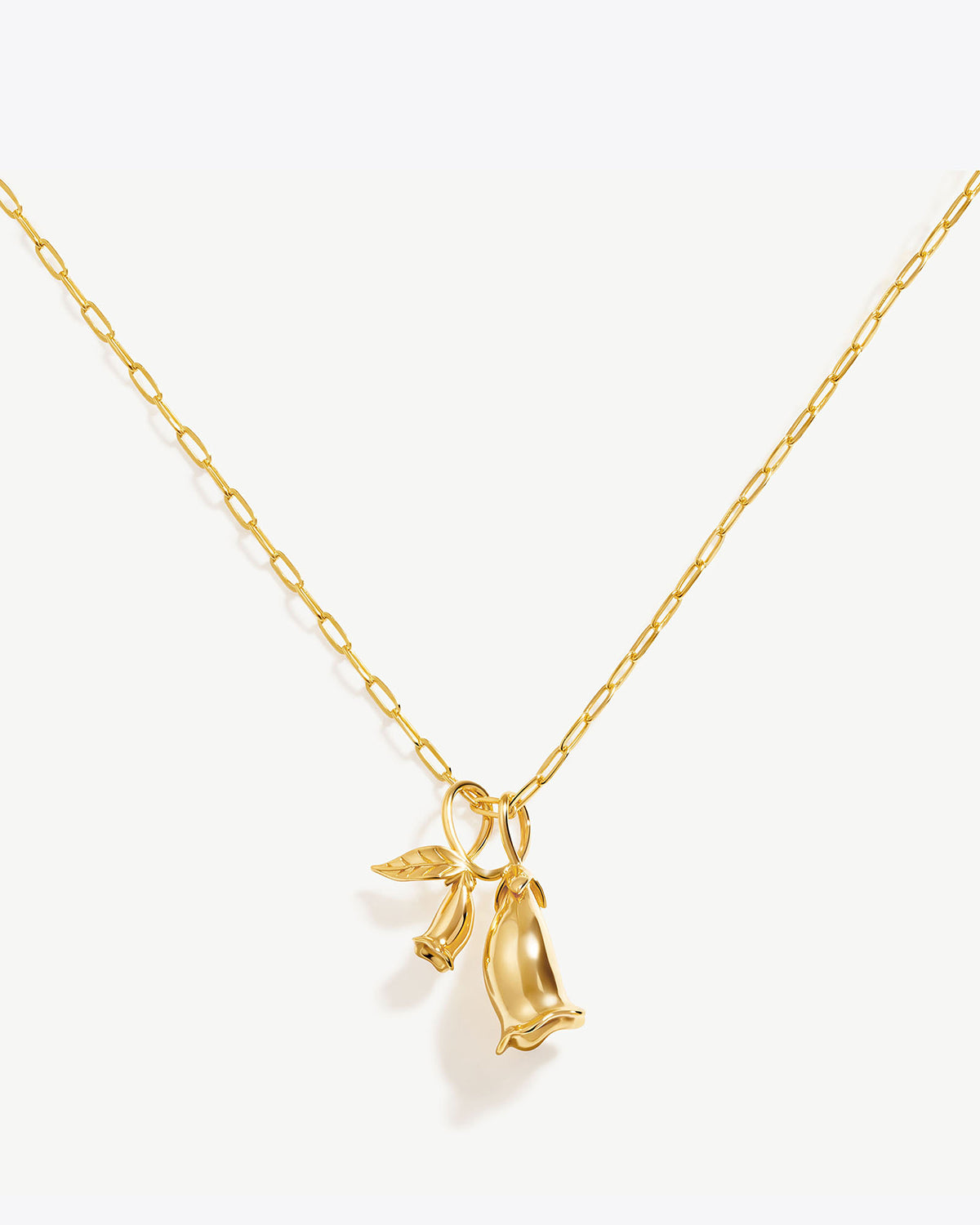 a gold necklace with a bird on it