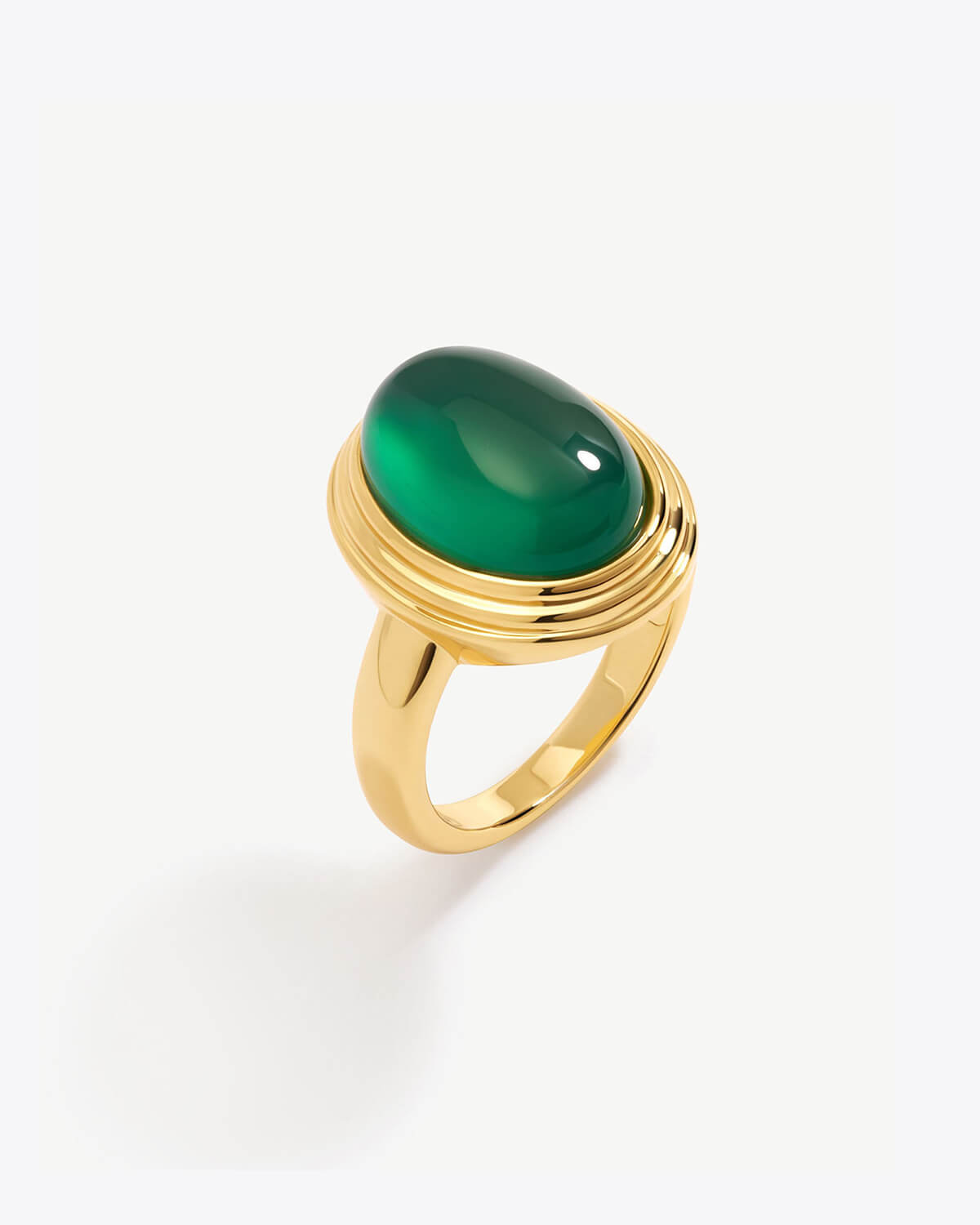 a gold ring with a green stone