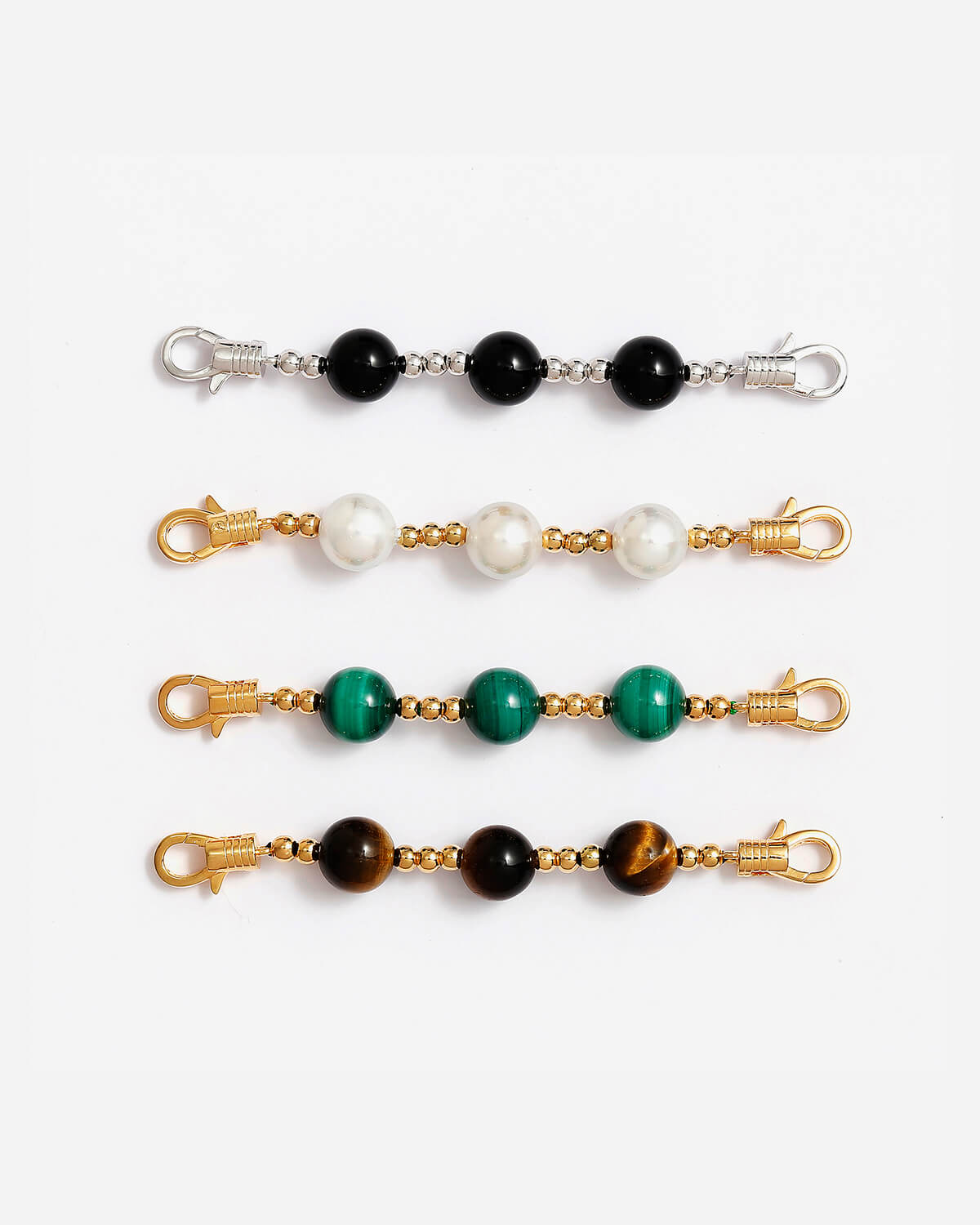 a set of four key chains with different colored beads