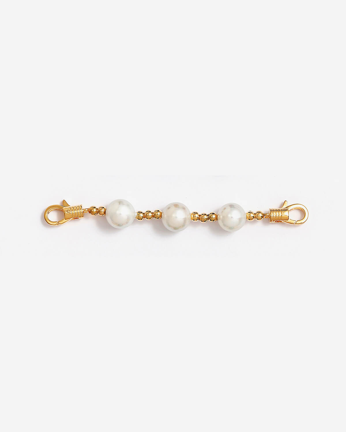 a pair of pearls on a gold chain