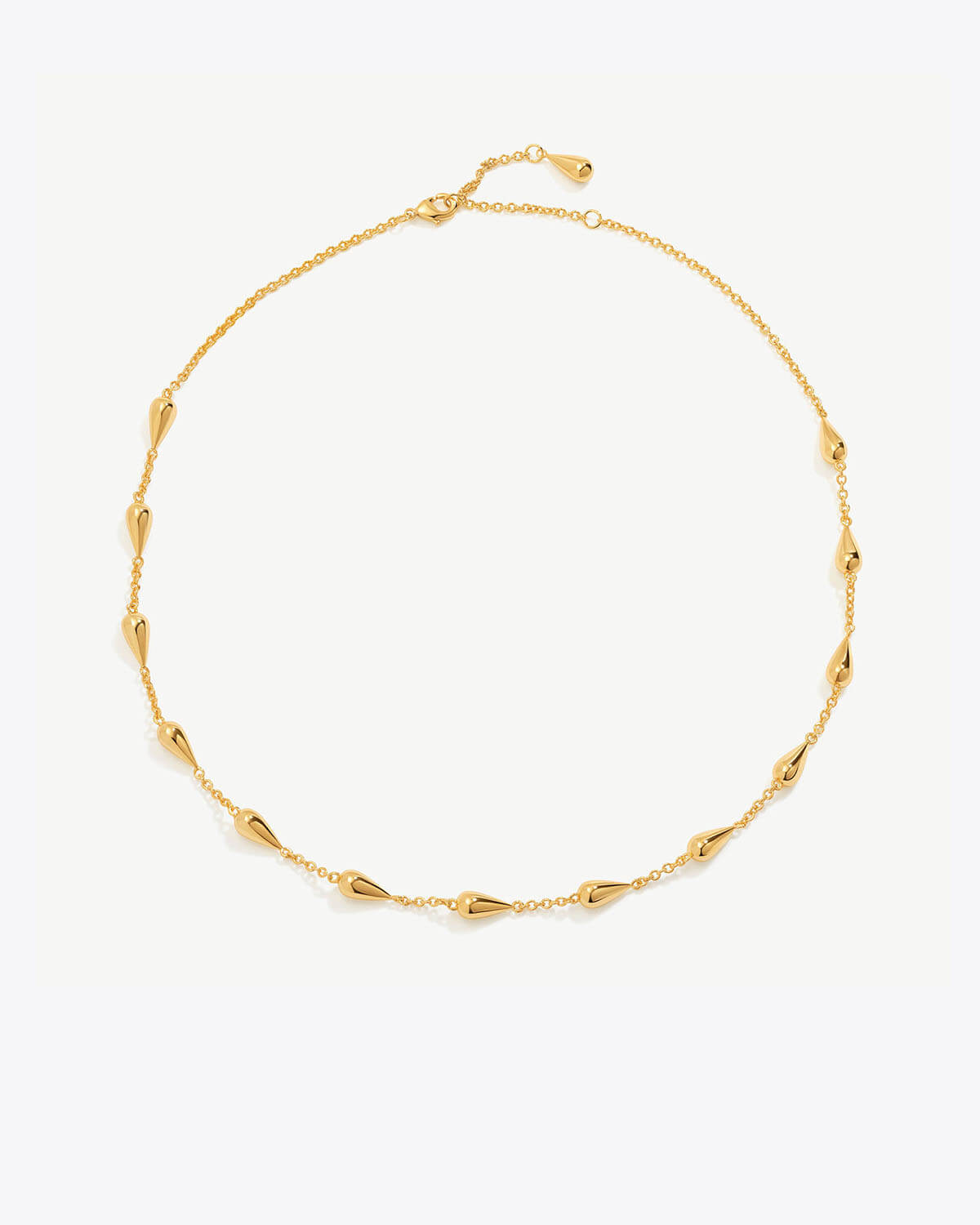 a gold chain bracelet with beads on a white background