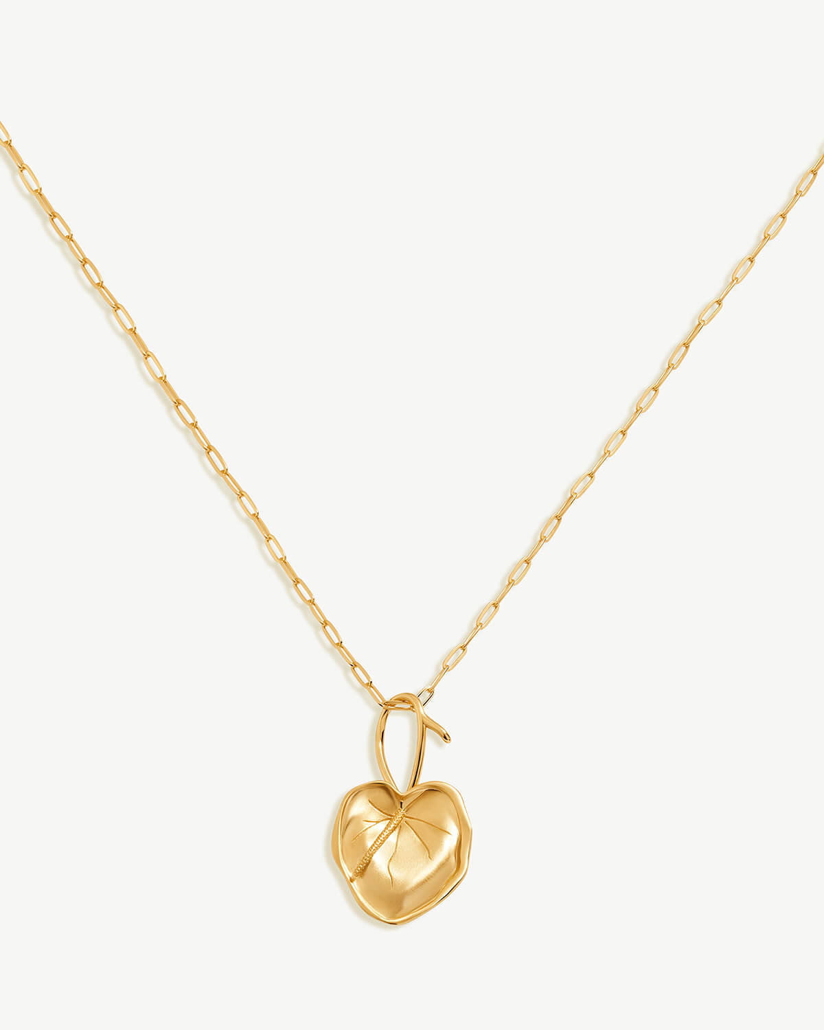 a gold heart pendant on a gold chain