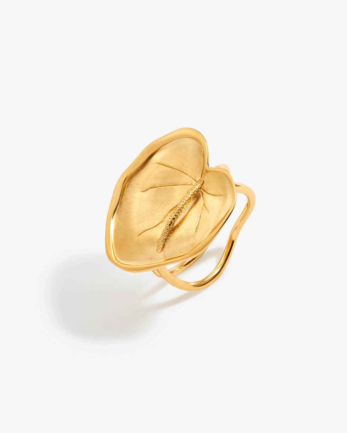 a gold ring with a leaf on it